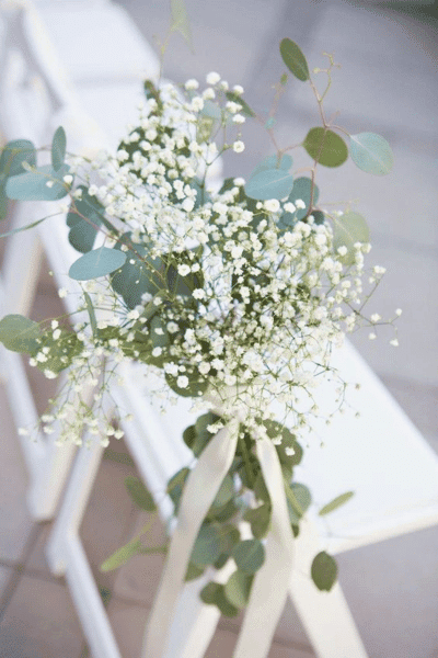 Gypsophila and eucalyptus wedding decoration chair pew end with ribbon