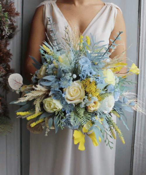 bride-carrying-a-spring-dusty-blue-yellow-bridal-bouquet