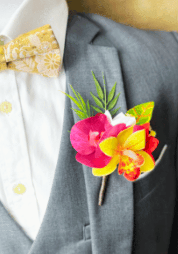 Tropical mangenta orchid boutonniere for groom and groomsmen