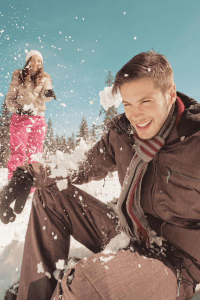 Playful Snowball Fight winter engagement photoshoot