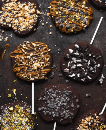 Chocolate covered apple slices on a stick